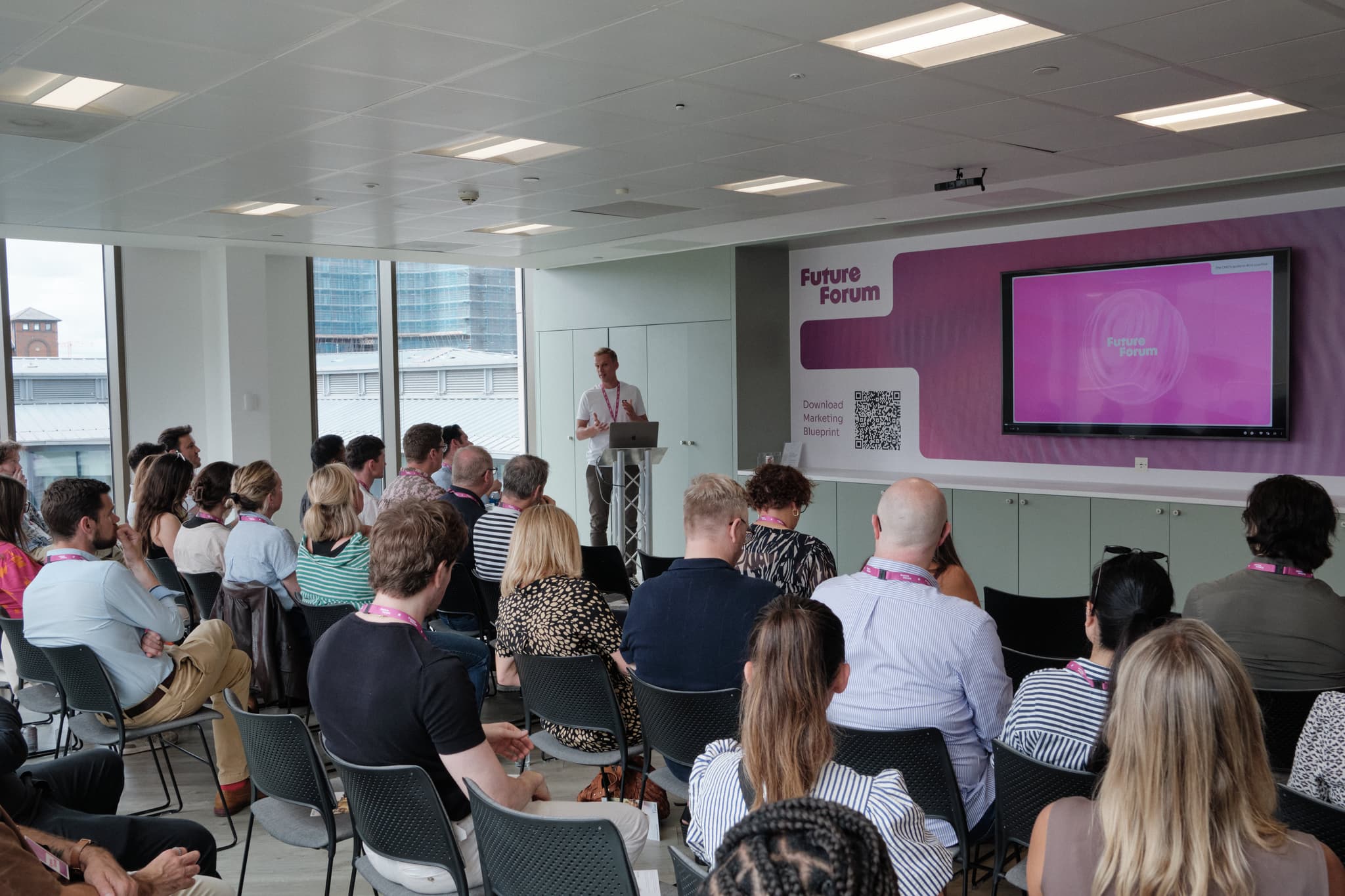A speaker presenting to a crowd at FutureForum